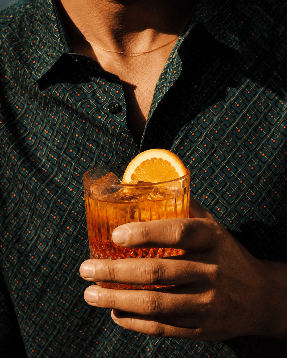 Citrus Club cocktail held in golden light.