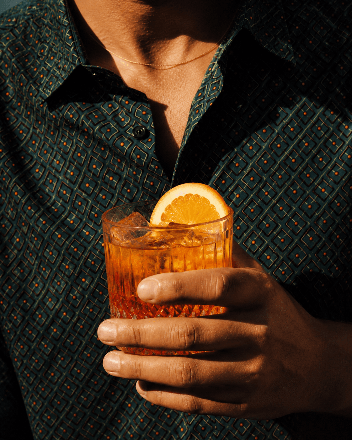 Citrus Club cocktail held in golden light.