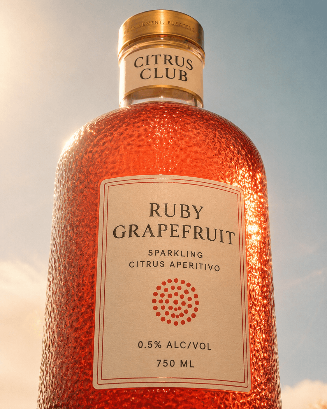 Ruby Grapefruit bottle photographed from below in sunlight.